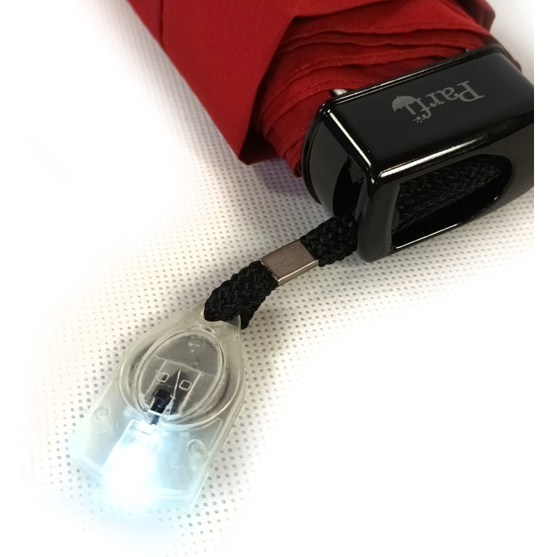 Small black umbrella with flashlight on handle